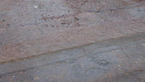 Heavy-rain-during-wet-season-with-water-running-down-the-road-during-monsoon-weather-in-Palawan,-Philippines,-Southeast-Asia