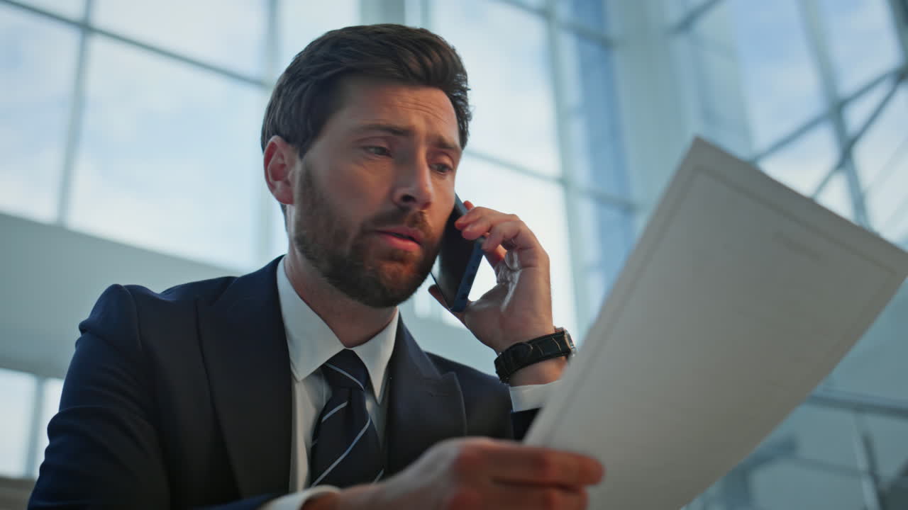 Worried manager speaking mobile phone reading deal closeup. Nervous executive