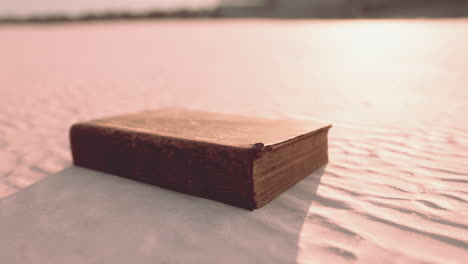 old book on the sand beach