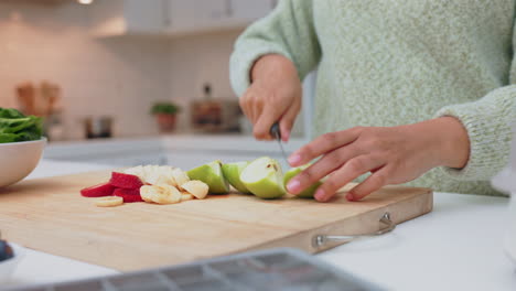 woman makes healthy salad in the kitchen