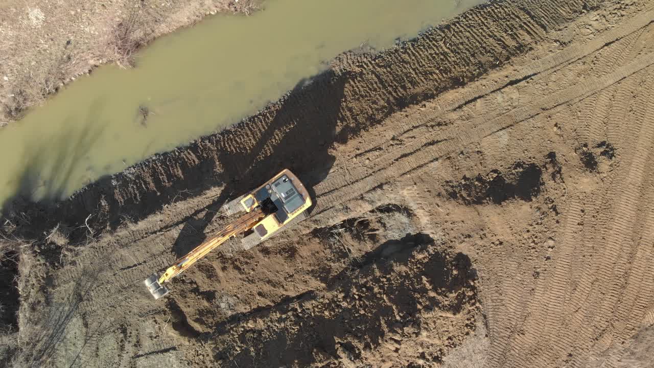 Excavator digging river channel after a flood. Aerial shot