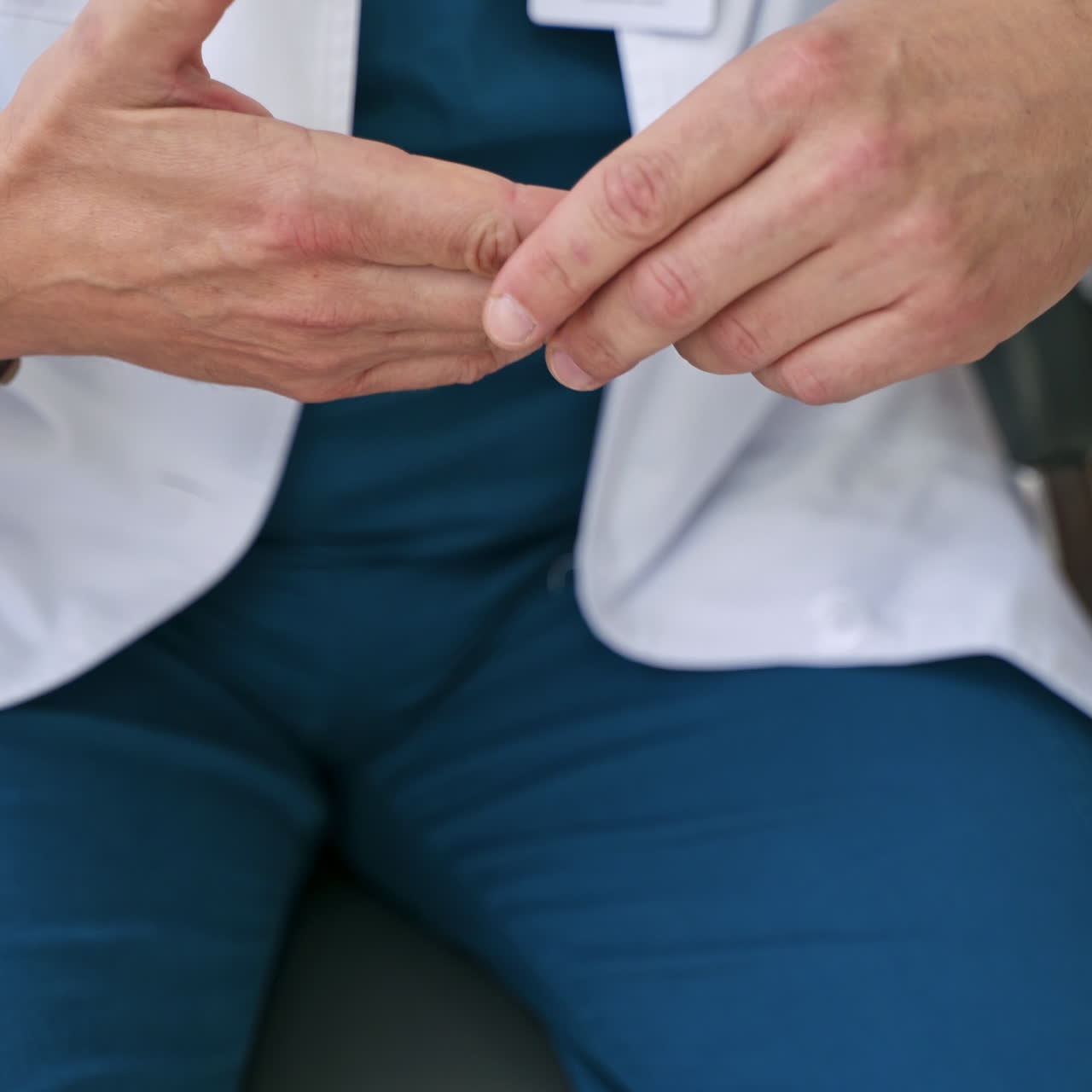 Doctor talks about the work of hand joints. Close-up specialist's hands showing the problems of arm physiotherapy. Healthcare concept.