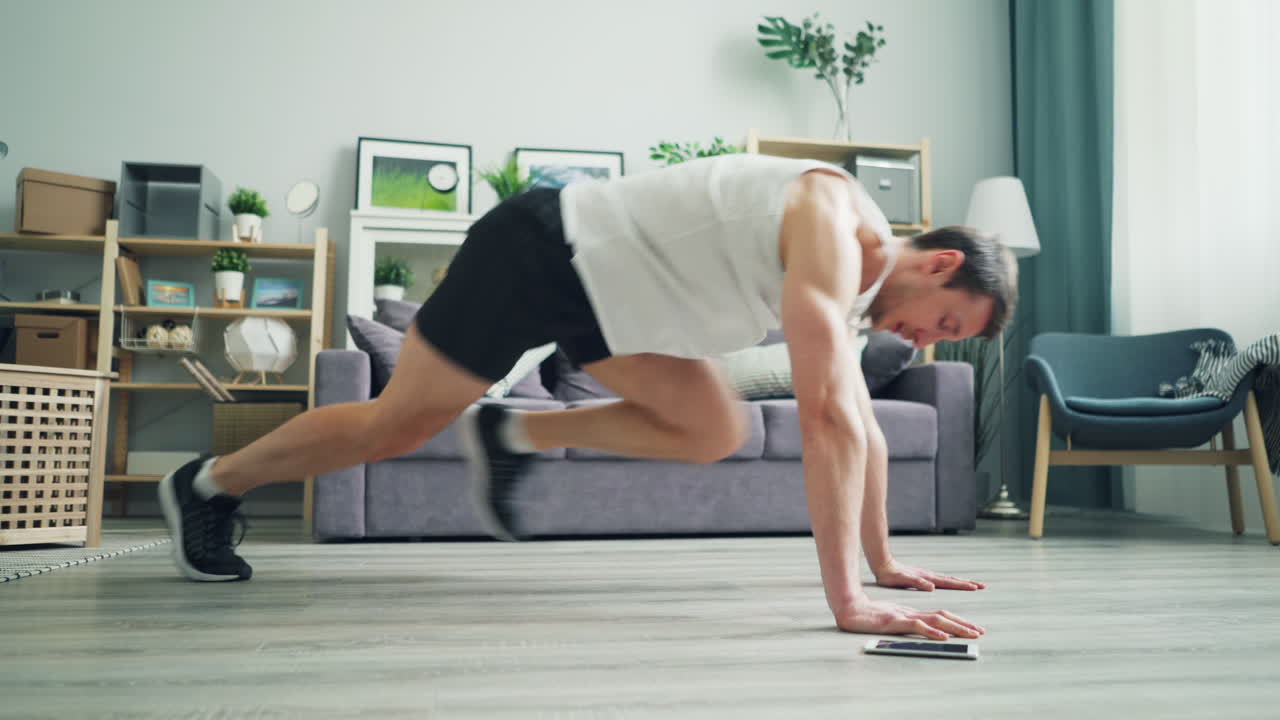 Man doing burpees at home