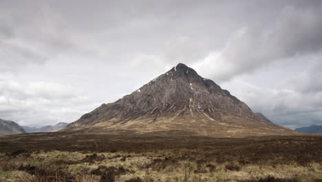 a timelapse of buachaille etive mor mountain with clouds passing from bottom left to top top right overhead, glencoe, scottish highlands, scotland