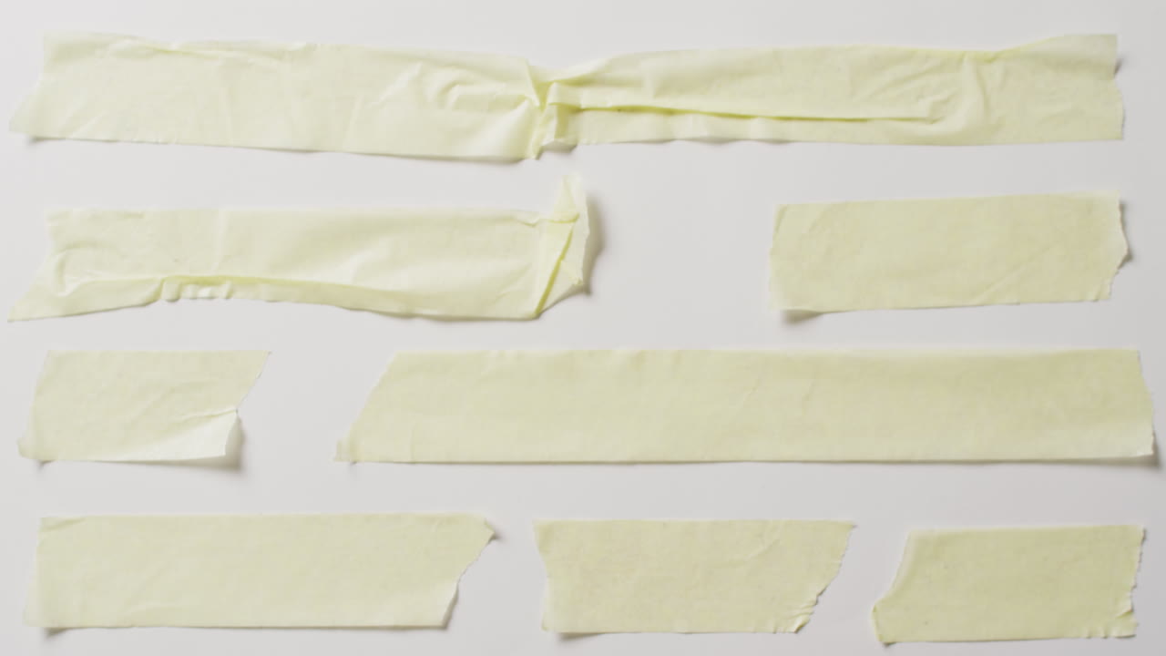 video de un primer plano de varias piezas rasgadas de papel amarillo con espacio de copia en un fondo blanco
