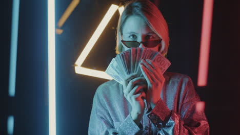 woman with money in neon lights