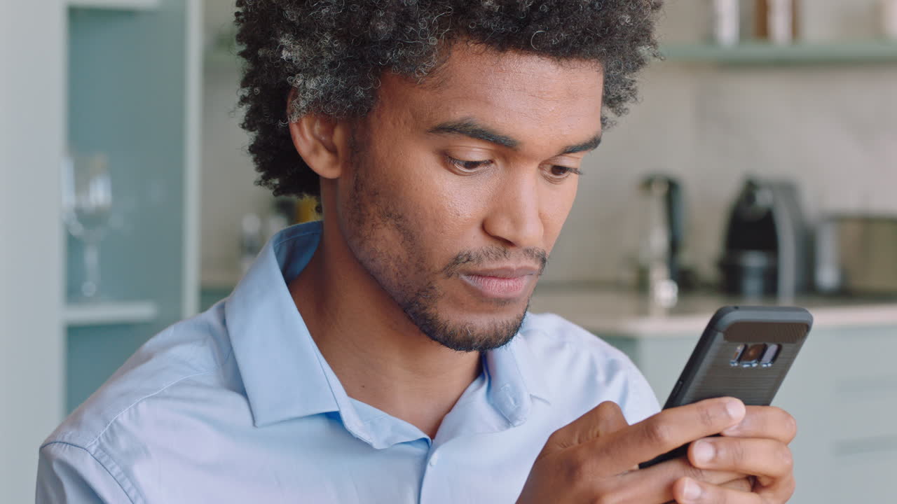 young man using smartphone texting social media messages browsing online enjoying mobile communication at home