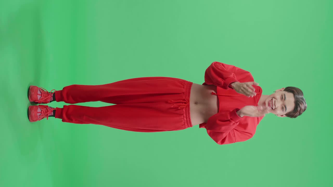 Full Body Of Young Asian Transgender Male Clapping His Hands In The Green Screen Studio