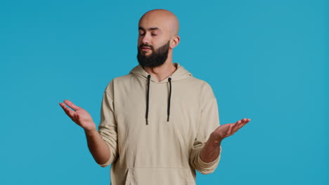 middle eastern guy showing i dont know gesture in studio