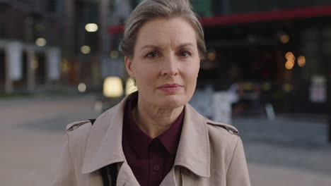 portrait of serious business woman focused intense turns head looking confident pensive in urban background