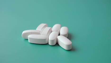 white pills on green background