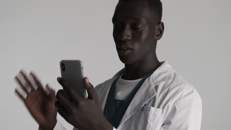 african american doctor on grey background.