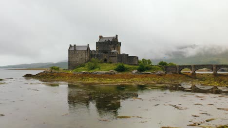 Atemberaubende-Luftaufnahme-Von-Eilean-Donan-Castle,-Das-Sich-Am-Loch-Duich-Im-Schottischen-Hochland-Spiegelt