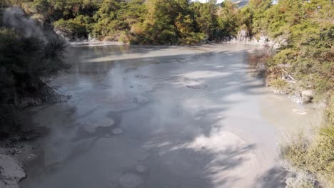 Static-aerial-shot-of-mud-boiling-in-the-Waiotapu-mud-pools,-Rotorua,-New-Zealand