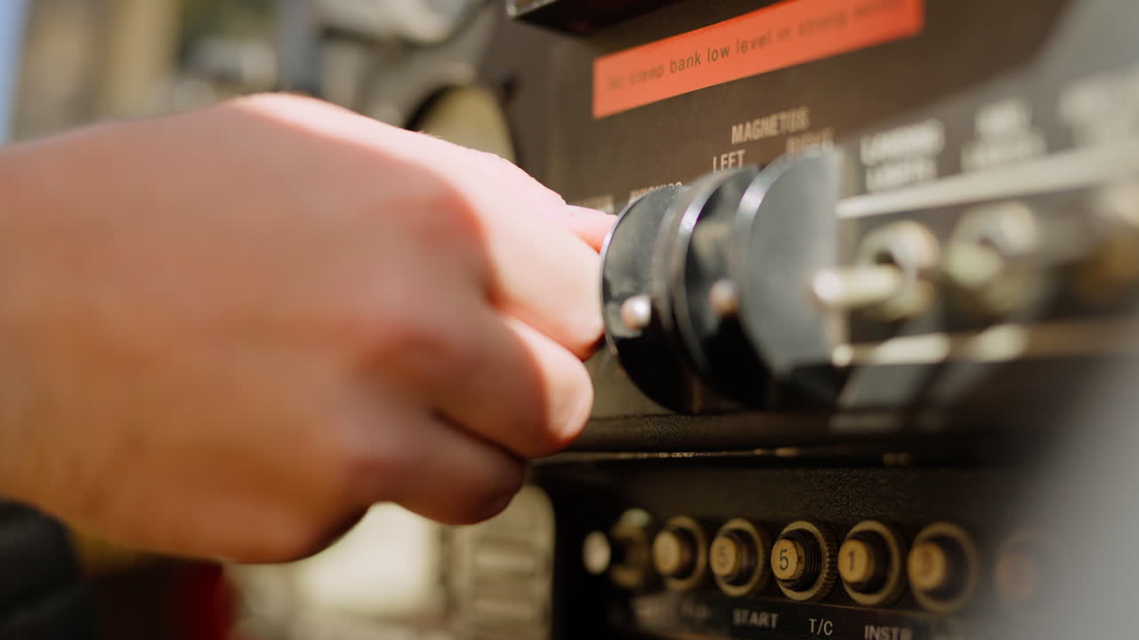 Pilot's Hand Operating Switches on Airplane Control Panel