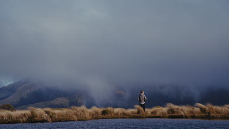 hiker gazing at misty mountain view