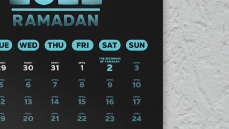 primer plano de una hermosa página de calendario negra con un horario de los días de ayuno de ramadán 2022 y la cámara se mueve a la fecha de eid al-fitr