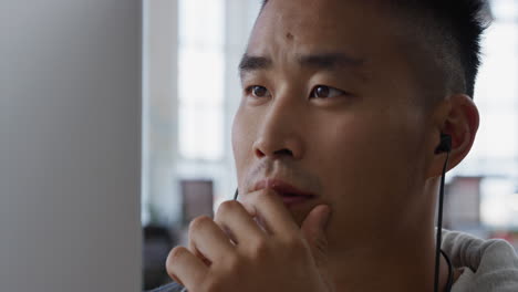 young asian man using computer brainstorming problem solving idea smiling enjoying successful solution in office