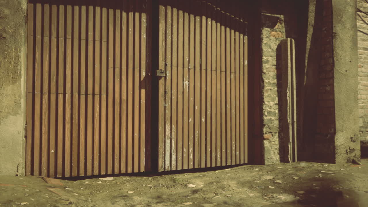 Wooden gate with intricate design in a rustic urban setting