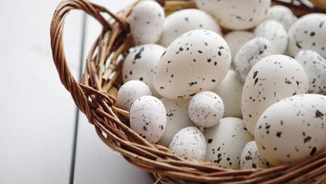 basket of white dotted easter eggs in brown wicker basket