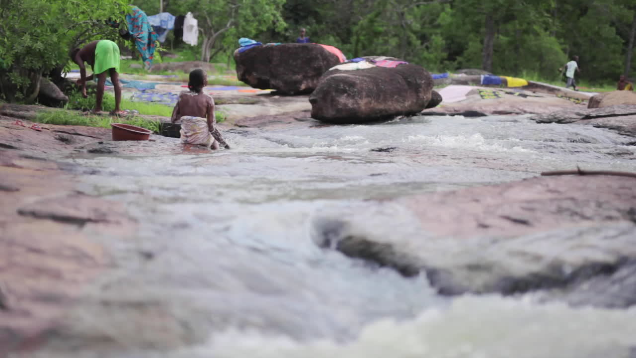 African people bathing at a river in Senegal