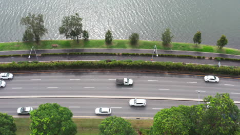 aerial top down drone shot of cars driving along the a4 road past the parramatta river bay run in sydney australia