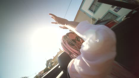 person enjoying a sunny convertible ride