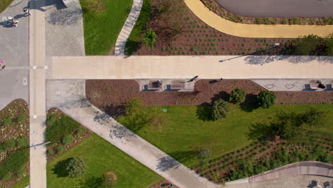 top down aerial - several paths in the park, modern infrastructure in the park, greenery and development of urban area