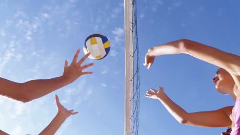 happy friends playing volleyball