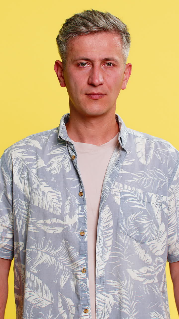 Adult man bending forward holding stomach with painful face suffering from cramps or abdominal pain