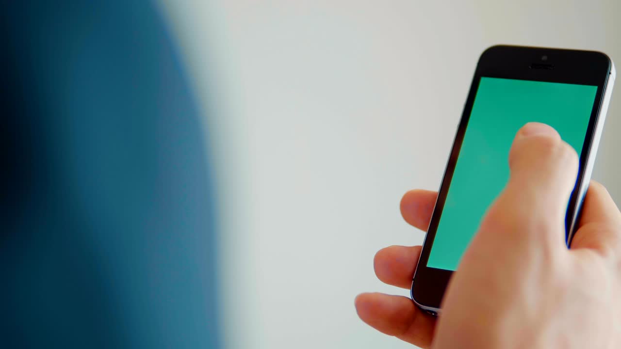 Smartphone With Green Screen Male Hands Detail Looking At Phone Tilt-Shot
