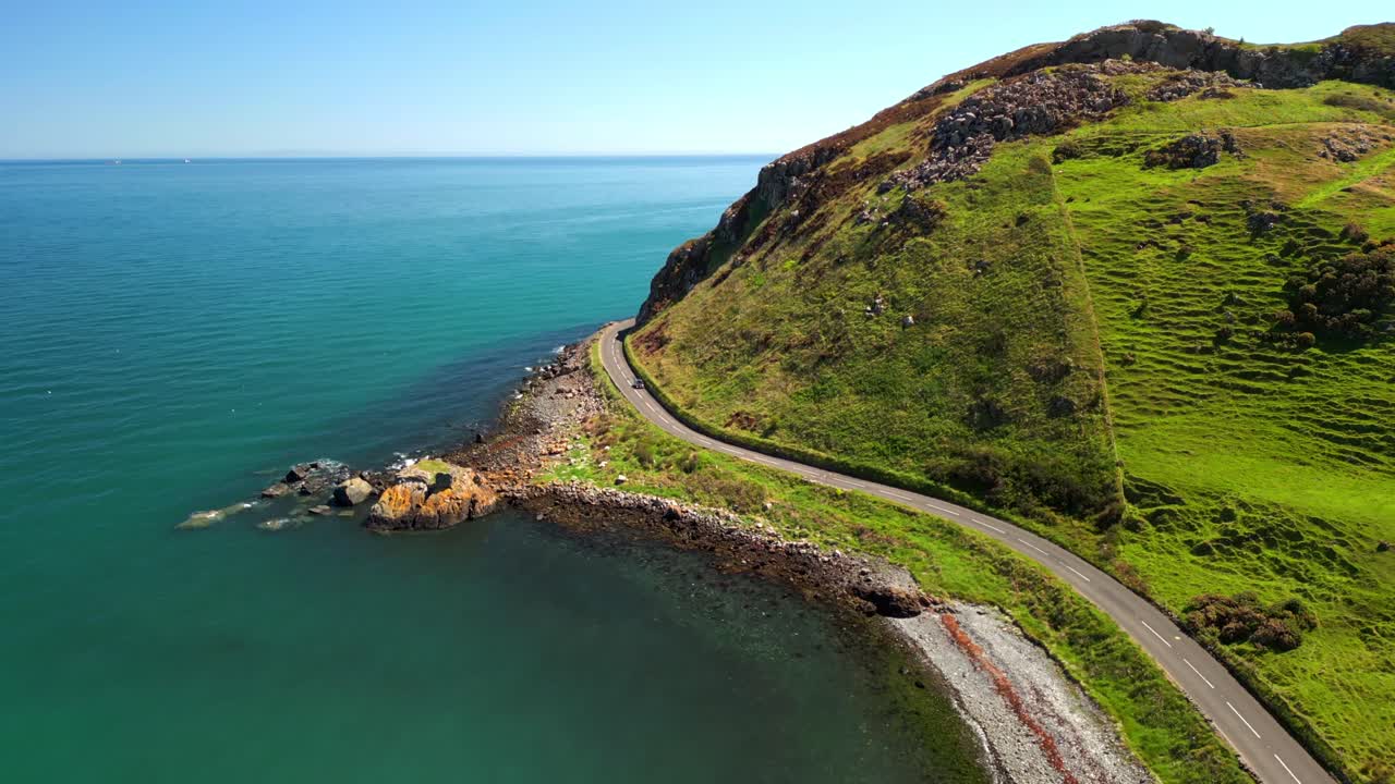 Wide rising aerial video of the Antrim Coastal Route on a bright and sunny day. Filmed in Ballygally in 4K, 60FPS and with Rec800 color.