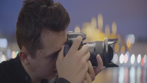 teenager taking night photos of cityscape