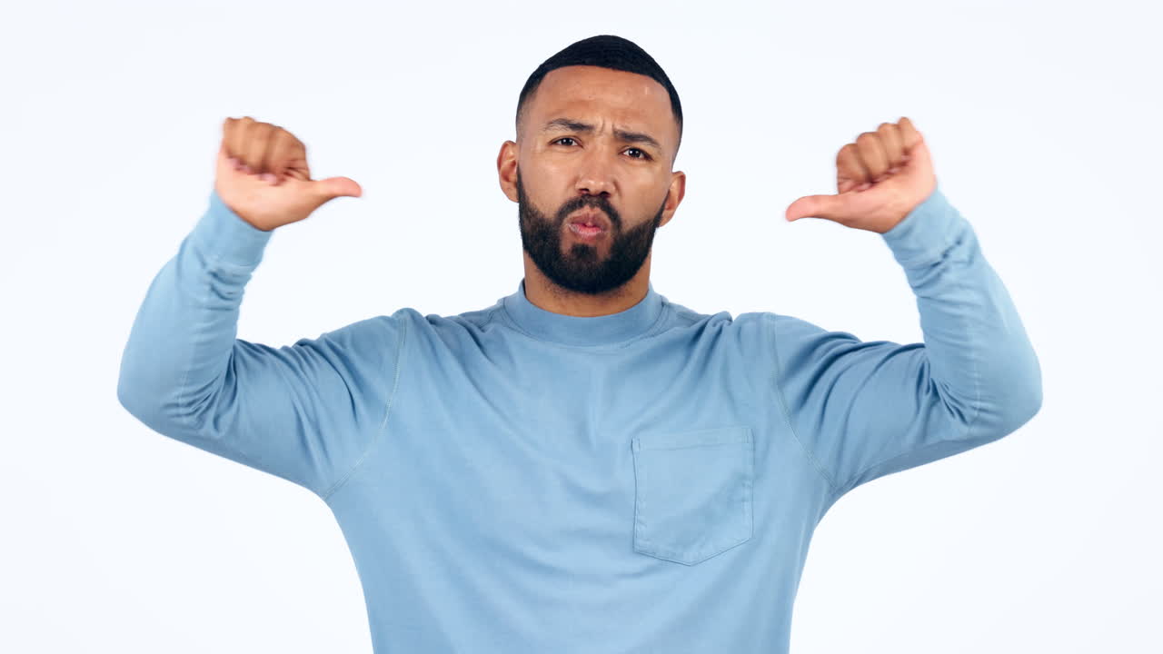 Thumbs down, face and hands of man in studio