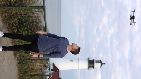 Vertical-view-of-person-take-off-drone-from-hand-near-Portland-Head-Light