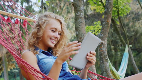 attractive woman rests in a hammock on a summer day 4