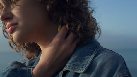 thoughtful woman posing at camera outdoors. dreamy girl looking sea horizon