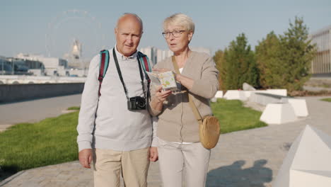 senior couple exploring city with map