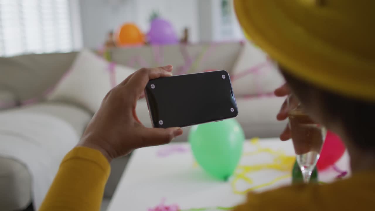 African american senior woman making new year's eve tablet video call, copy space on screen