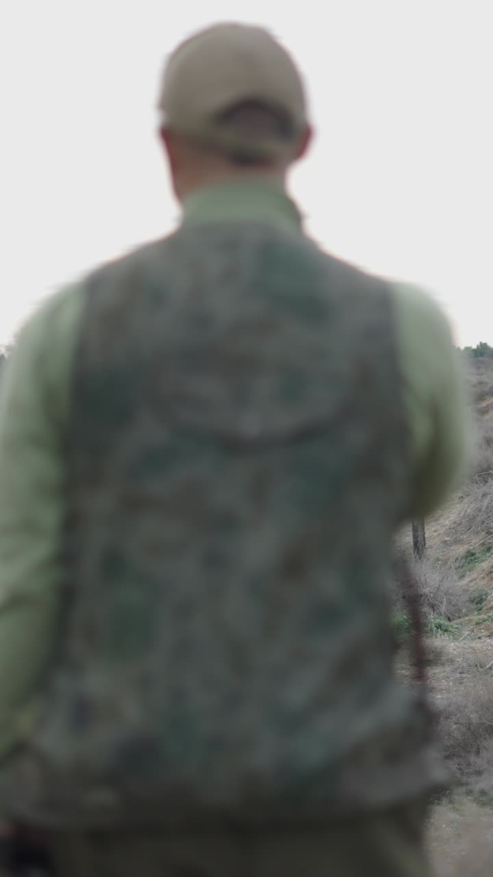 Man in Camouflage Vest Outdoors