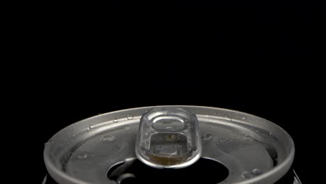 macro of open soda can tab with droplets