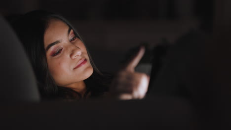 beautiful-teenage-girl-using-tablet-computer-watching-entertainment-at-night-browsing-online-enjoying-relaxing-evening