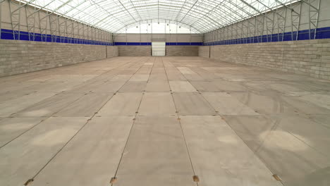 aerial dolly forward shot of a empty large agricultural grain warehouse