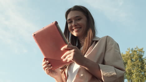woman using tablet computer outdoors