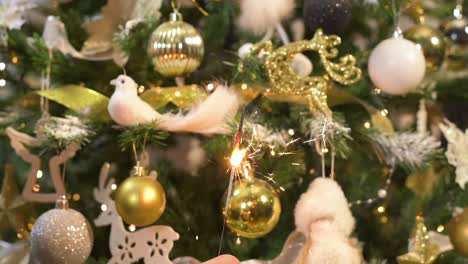 burning sparkle fire in front of decorated christmas tree. slow motion