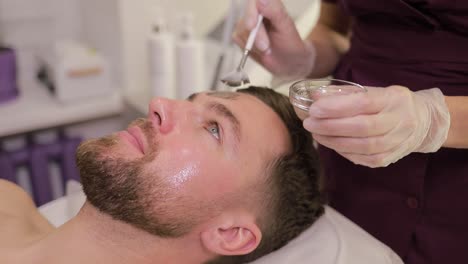 man receiving a facial treatment