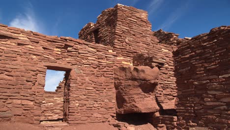 a moving shot revealing a stone doorway of the largest pueblo ruins at wupatki national monument in arizona