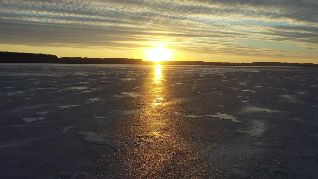 Golden Sunset Reflection on a Vast Frozen Lake
