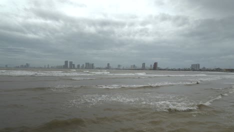 tropical sea waves and dramatic dark sky above