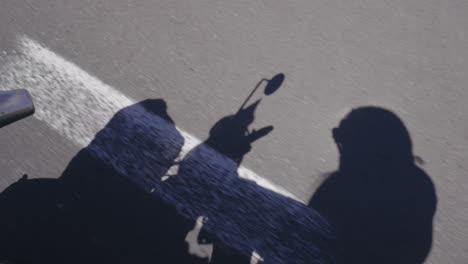 biker shadow traveling on road. travel concept. real time, high angle